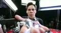 Smiling young man blowing confetti from hand towards camera, studio backstage HD Footage