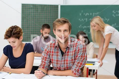 Smiling young man at college or university Stock Photos