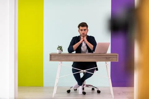 Smiling young man freelancer using laptop studying online working from home Foto stock