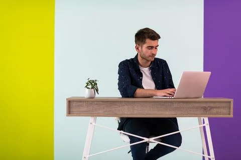 Smiling young man freelancer using laptop studying online working from home Fotos de archivo
