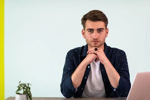 Smiling young man freelancer using laptop studying online working from home Fotos de archivo