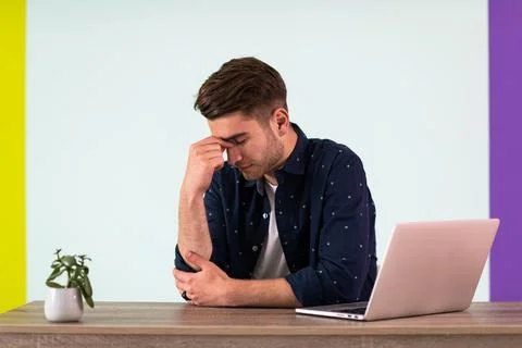 Smiling young man freelancer using laptop studying online working from home 写真素材