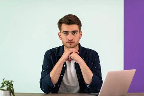 Smiling young man freelancer using laptop studying online working from hom... 写真素材