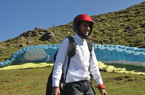 A smiling young man getting ready for paragliding flight Stock Photos