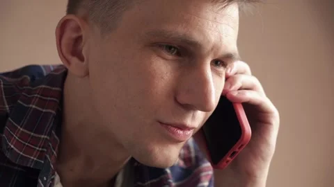 Smiling young man having a discussion on a mobile phone. close-up Stock Footage 207779662