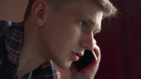 Smiling young man having a discussion on a mobile phone. Видео 208876714