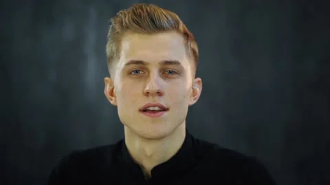 Smiling young man look at camera and recording vlog in loft studio Video stock 131548568