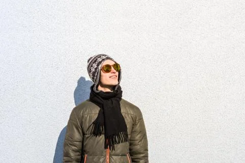 Smiling young man posing outdoors. Male teenager person stands at minimalisti Stock Photos