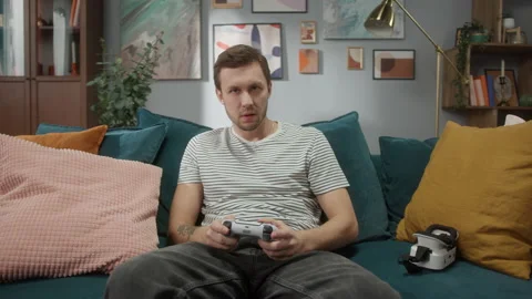 Smiling young man sitting, looking at camera, portrait of handsome male relaxing Video stock 150441718