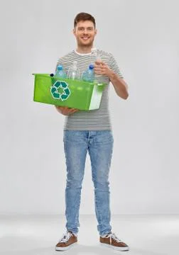 Smiling young man sorting plastic waste Stock Photos