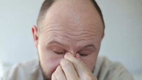 Smiling young man takes off his glasses and rubs his eyes Stock-Footage 242720475