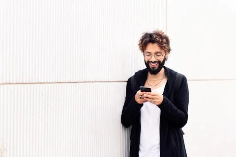 Smiling young man talking on mobile phone Stock Photos