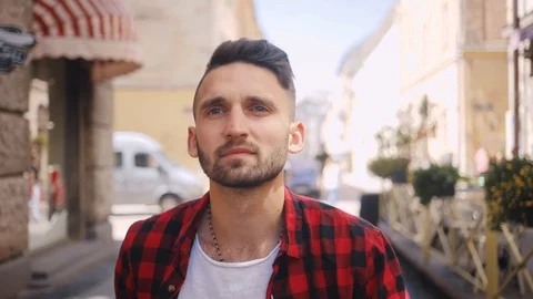 Smiling young man use phone walk in city feel happy surprised blurred background Stock Footage 92069980