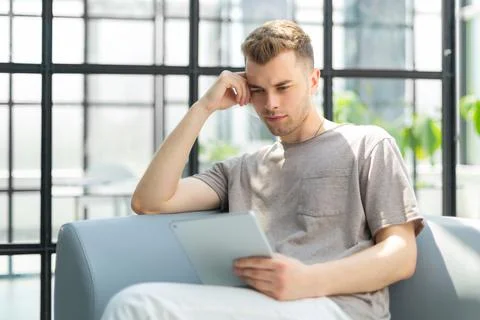 Smiling young man using digital tablet in the office Foto stock