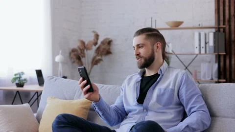 Smiling young man using smartphone for online meeting, video call, video Stock-Footage 166099269