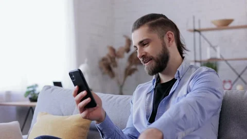 Smiling young man using smartphone for online meeting, video call, video 스톡 동영상 181504133