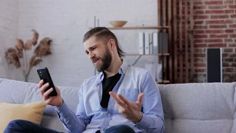 Smiling young man using smartphone for online meeting, video call, video Stock Footage 203796783