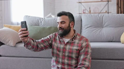 Smiling young man using smartphone for online meeting, video call, video Video stock 213275876