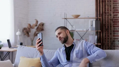 Smiling young man using smartphone for online meeting, video call, video Stock Footage 234149927