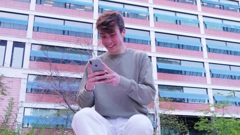Smiling Young Man Using Smartphone Outside Office Building Stock Footage 296059342