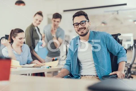 Smiling young man working with startup project in office Stock Photos