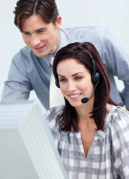 Smiling young manager checking his employee's work Stock Photos