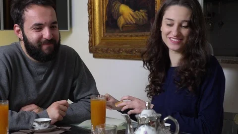 Smiling young married couple making breakfast in the morning Stock-Footage 92779760