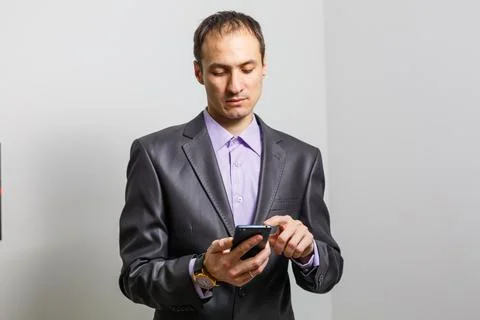 Smiling Young Middle Eastern Man With smartphone Stock Photos