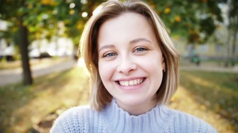 Smiling young model looking at camera, happy beautiful lady posing outdoor Stock Footage 141539843