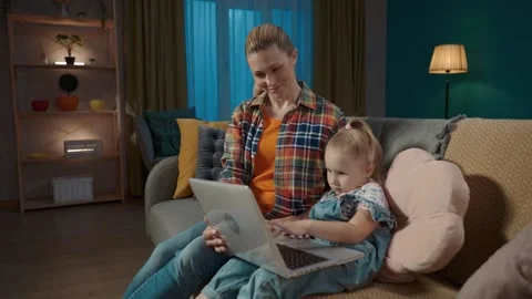 Smiling young mom teaching her daughter how to use computer applications. Mom Stock Footage 254212958