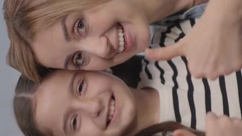 Smiling young mother looking at camera with happy little cute daughter. Stock Footage 152017943