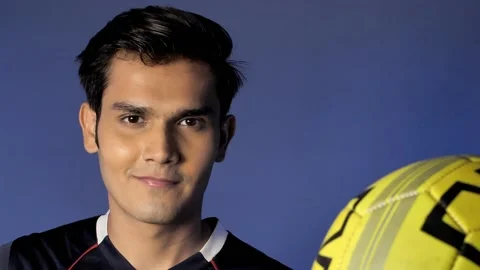 Smiling young player posing with a ball while standing against a colorful bac... Stock Footage 154340412