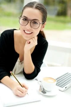 Smiling young student doing e-learning Stock Photos