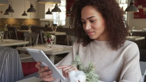 Smiling young woman chatting using tablet PC. May depict third Party IP Видео 72712895