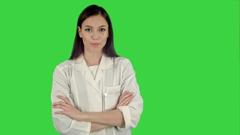 Smiling young woman in lab coat talking to the camera on a Green Screen, Chroma Vídeos de archivo 71754300