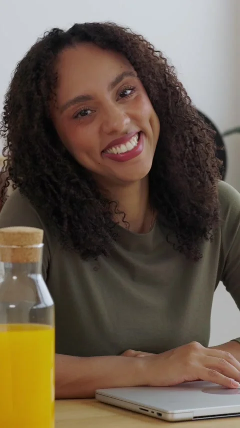 Smiling young woman looking at camera while working from hom Stock Footage 346256037
