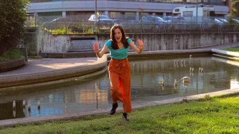 Smiling young woman performs synchonized dance steps looking at the camera Stock Footage 154134349