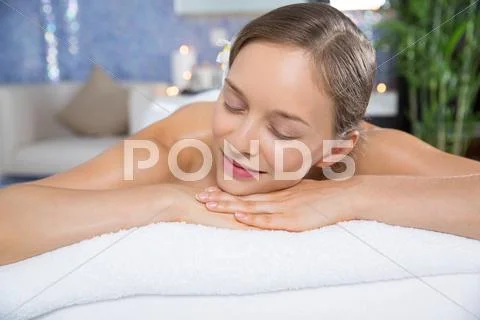 Smiling young woman relaxing after spa treatment Stock Photos