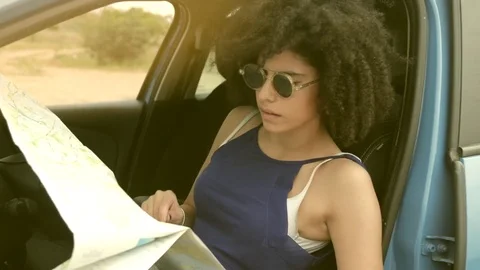 Smiling young woman using map to plan trip Stock Footage 74057529