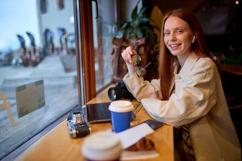 Smiling young woman watching tutorial online on modern laptop device Stock Photos