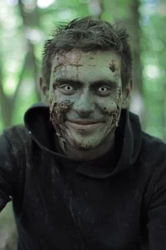 Smiling zombies in a forest. Stock Photos