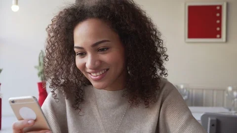 Smilingyoung woman chatting using mobile phone. May depict third Party IP Stock Footage 72644232