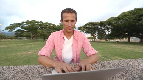 Smilling Man Using Computer In The Park Stock Footage 55629822