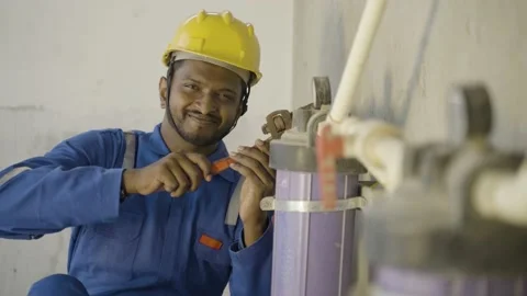 Smilling young indian engineer or repairman showing thumbs up sign or hand Video stock 168731012