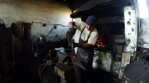 A Smith and His Apprentice Handles a Workpiece in an Ancient Smithy 스톡 동영상 59762001