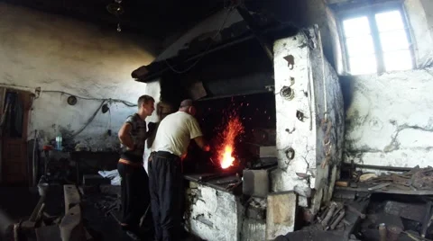 Smith and His Apprentice is Heated in the Forge Iron Detail of a Water-Powered Video stock 59761267