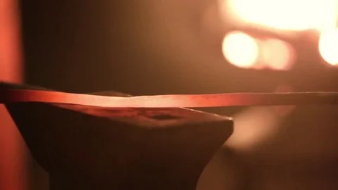 Smith beats the hammer on a metal workpiece Stock Footage 74339044