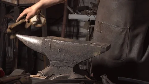 Smith cleans the anvil Stock Footage 77408830