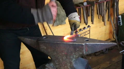 Smith forges a horseshoe on an anvil in a smithy Stock Footage 45942073