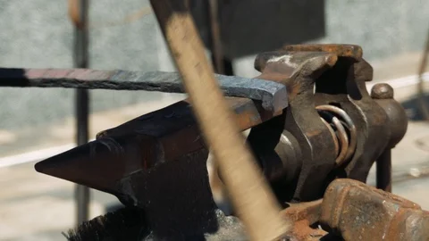 Smith forming red hot iron in hook on anvil. Blacksmith in forge beats hammer Stock-Footage 110836454